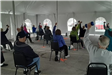 Strength conditioning under a large tent.