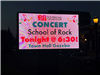 the digital sign in front of town hall promoting the School of Rock concert